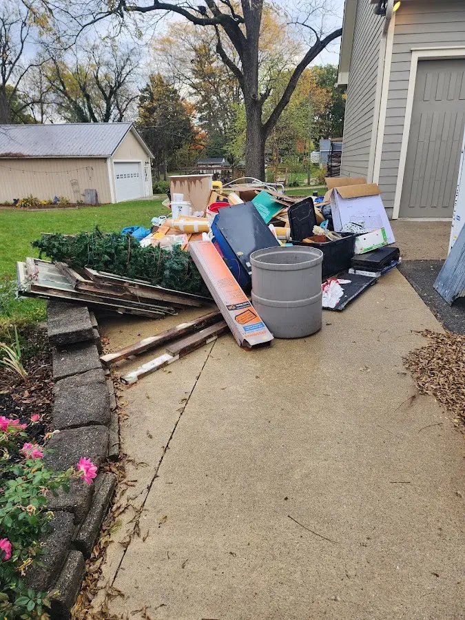 Dumpster being loaded with debris for Estate Cleanout Dumpster Rental in North Wales
